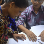 Worker signing her name
