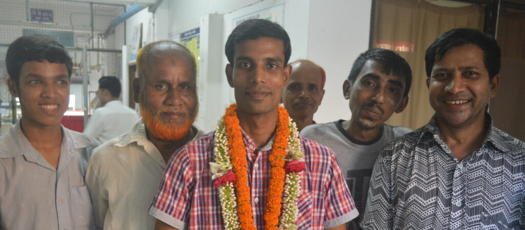 An election winner, a man, surrounded by 5 male supporters