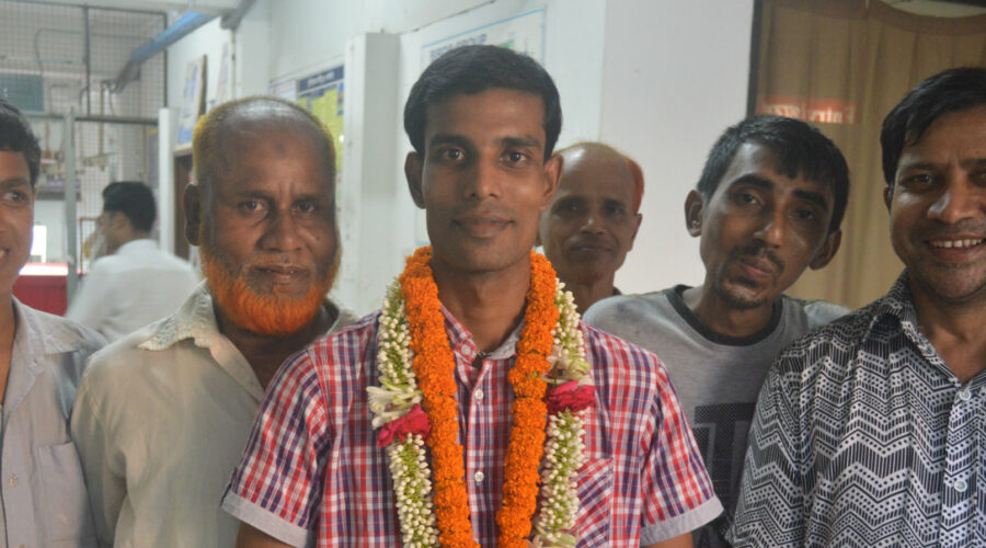An election winner, a man, surrounded by 5 male supporters